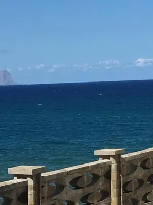 a view of the ocean from a stone fence at LA FINESTRA SUL MARE PIANO Terra in Trappeto