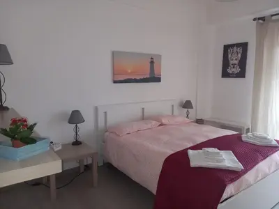 a bedroom with a bed and a table and a lighthouse at La Casa di Andly in Palermo
