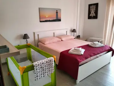 a small bedroom with a bed and a lighthouse at La Casa di Andly in Palermo