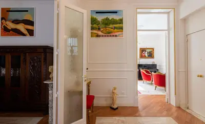 a hallway with a door leading to a dining room at Le Rose di Nonna Maria, appartamento di lusso in centro città in Palermo