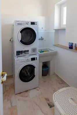 a kitchen with two washing machines and a sink at Le Rose di Nonna Maria, appartamento di lusso in centro città in Palermo