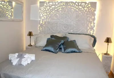 a bedroom with a bed with a large headboard at La Siciliana-di fronte la Cattedrale in Palermo