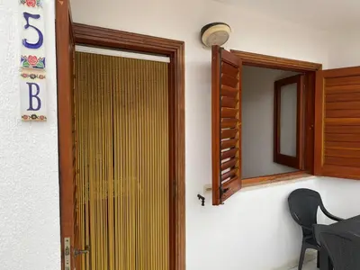a door to a room with a mirror at Appartamento Blusanvito 1° Piano in San Vito lo Capo
