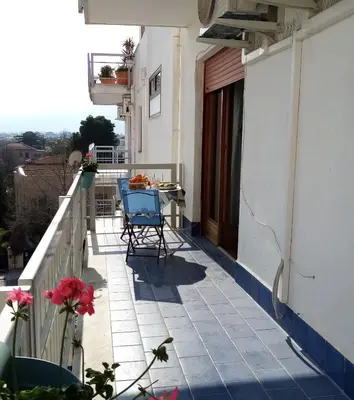 a balcony of a house with a table and chairs at Casa Rosamarina in Mondello