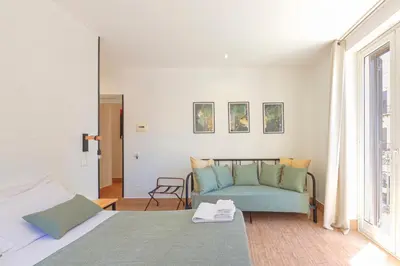 a bedroom with a bed and a couch at La Ciconella in Palermo