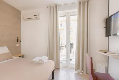 a hotel room with a bed and a window at La Ciconella in Palermo