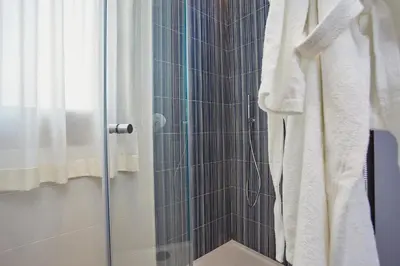 a shower with a glass door in a bathroom at Villa Etesiae in Castellammare del Golfo