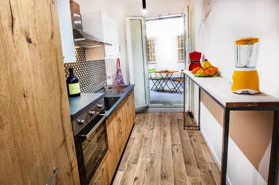 a kitchen with wooden cabinets and a counter top at Casa del Capo in Palermo