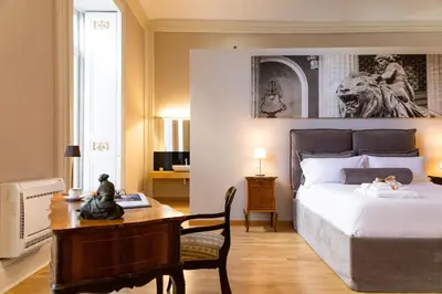 a bedroom with a bed and a desk with a desk at Divisi Suites & SPA in Palermo