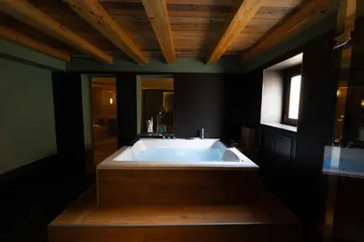 a large bath tub in a bathroom with black walls at Divisi Suites & SPA in Palermo