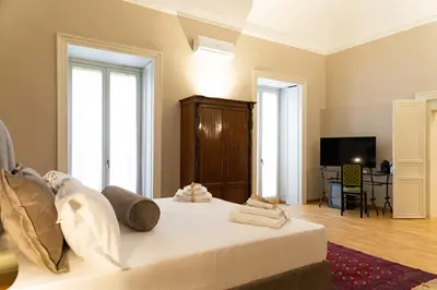 a bedroom with a bed with towels on it at Divisi Suites & SPA in Palermo