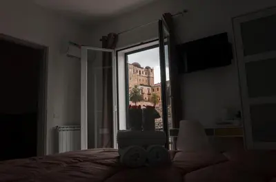 a bedroom with a bed with a view of a building at La Piccola Formica Charme Rooms in Palermo
