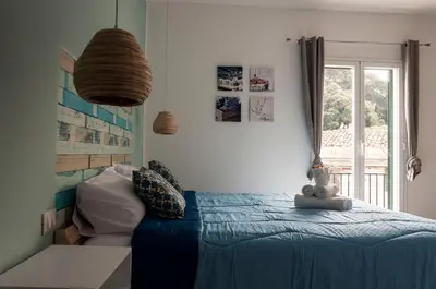 a bedroom with a blue bed and a window at La Piccola Formica Charme Rooms in Palermo