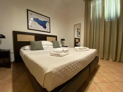 a bedroom with a large bed with towels on it at Le stanze di Ruggero in Palermo