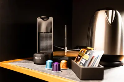 a desk with a coffee maker and other items on it at Miceli Exclusive Suite in Palermo
