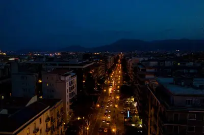 a view of a city at night with lights at Miceli Exclusive Suite in Palermo