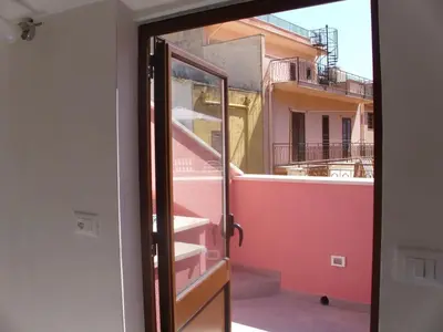 an open door with a view of a building at Charming House in Castellammare del Golfo with Balcony in Castellammare del Golfo