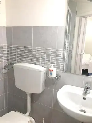 a bathroom with a toilet and a sink at Charming House in Castellammare del Golfo with Balcony in Castellammare del Golfo