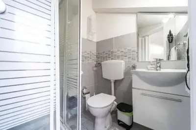 a bathroom with a toilet and a sink and a mirror at Charming House in Castellammare del Golfo with Balcony in Castellammare del Golfo