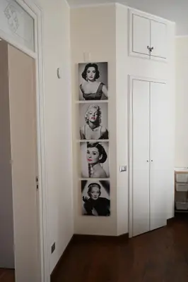 a room with a wall with pictures of a woman at Anna's Luxury Apartment in Palermo