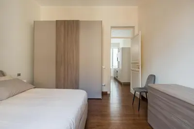 a bedroom with a bed and a chair in it at Anna's Luxury Apartment in Palermo
