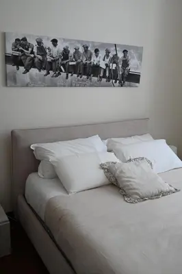 a black and white photo of a group of people sitting on a bed at Anna's Luxury Apartment in Palermo