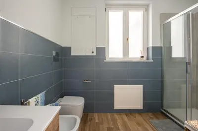 a bathroom with a toilet and a sink and a window at Anna's Luxury Apartment in Palermo