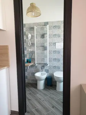 a bathroom with a toilet and a sink at DIMENTICA IL CERVELLO in Palermo