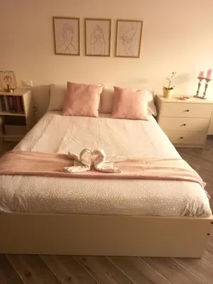 a bedroom with a bed with a bow on it at DIMENTICA IL CERVELLO in Palermo