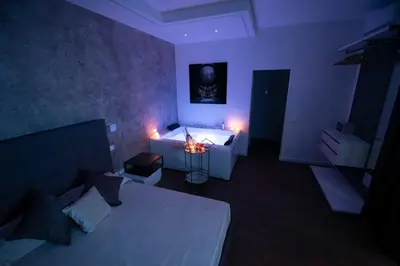 a bedroom with a bed and a tub in a room at Fervore Luxury Rooms in Palermo