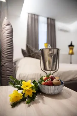 a table with a bowl of fruit and a blender at Fervore Luxury Rooms in Palermo