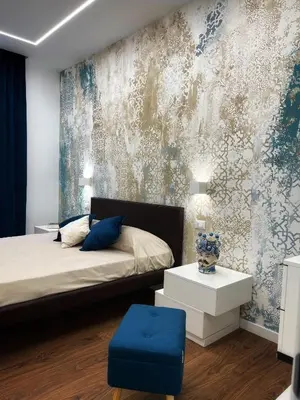 a bedroom with a bed with a blue ottoman at Fervore Luxury Rooms in Palermo