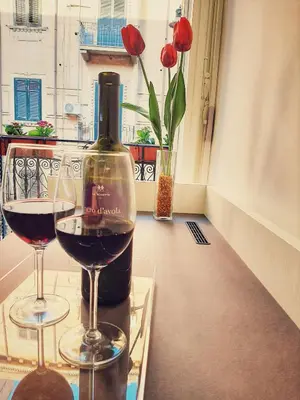 a bottle of wine next to a glass of wine at Ai Quartieri in Palermo