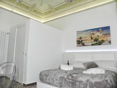 a bedroom with a bed with a painting on the ceiling at Ai Quartieri in Palermo