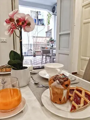 a table with a plate of food and a cake at Ai Quartieri in Palermo