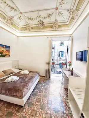 a bedroom with a bed and a coffered ceiling at Ai Quartieri in Palermo
