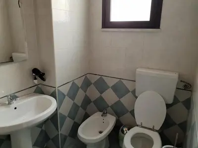 a bathroom with a toilet and a sink at Stanze Di Leo in Palermo