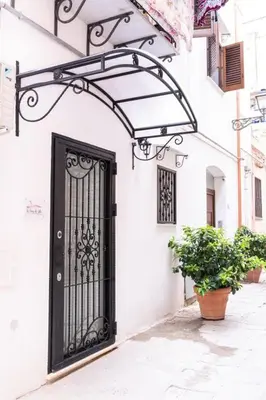 a black door on the side of a building at La Casa di Lilù in Palermo
