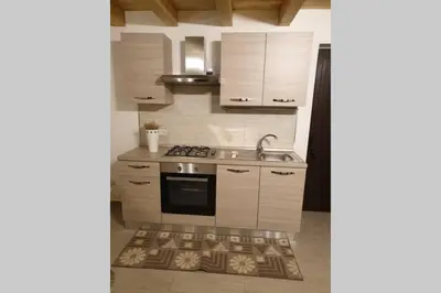 a kitchen with a sink and a stove top oven at Appartamento VITTORIA in Palermo