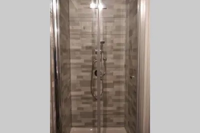 a shower with a glass door in a bathroom at Appartamento VITTORIA in Palermo