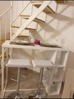 a white table with two plates and two stools at Appartamento VITTORIA in Palermo
