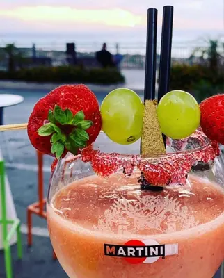 a martini with fruit on the top of it at B&B Rainbow in Campofelice di Roccella