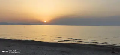 a sunset over a body of water with a beach at B&B Rainbow in Campofelice di Roccella