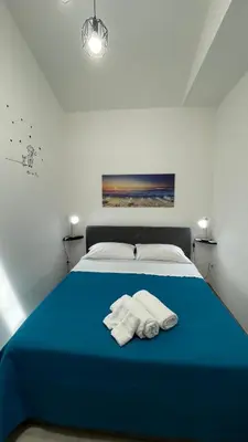 a bedroom with a blue bed with towels on it at Casa vacanza 
