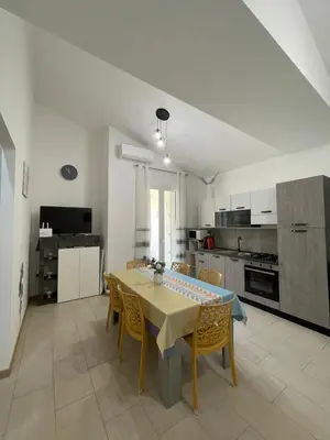 a kitchen and dining room with a table and chairs at Casa vacanza 