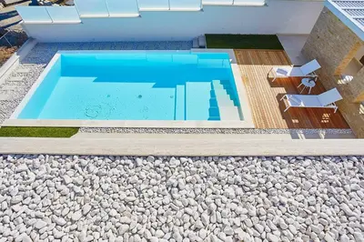 a swimming pool with some chairs next to it at VILLA DARDA con piscina e 3 camere da letto in Alcamo