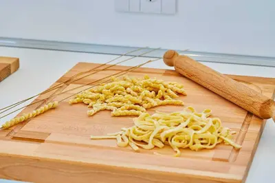 a pile of pasta on a wooden cutting board at VILLA DARDA con piscina e 3 camere da letto in Alcamo