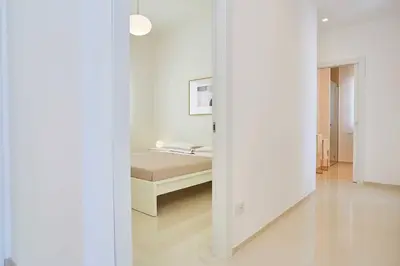 a bedroom with a bed in a white room at VILLA DARDA con piscina e 3 camere da letto in Alcamo