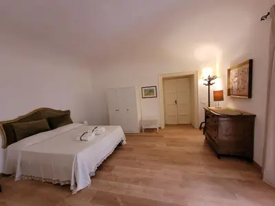 a bedroom with a bed and a dresser in it at Appartamento in centro Titi's place in Palermo