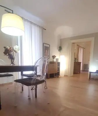 a living room with a table and chairs and a lamp at Appartamento in centro Titi's place in Palermo